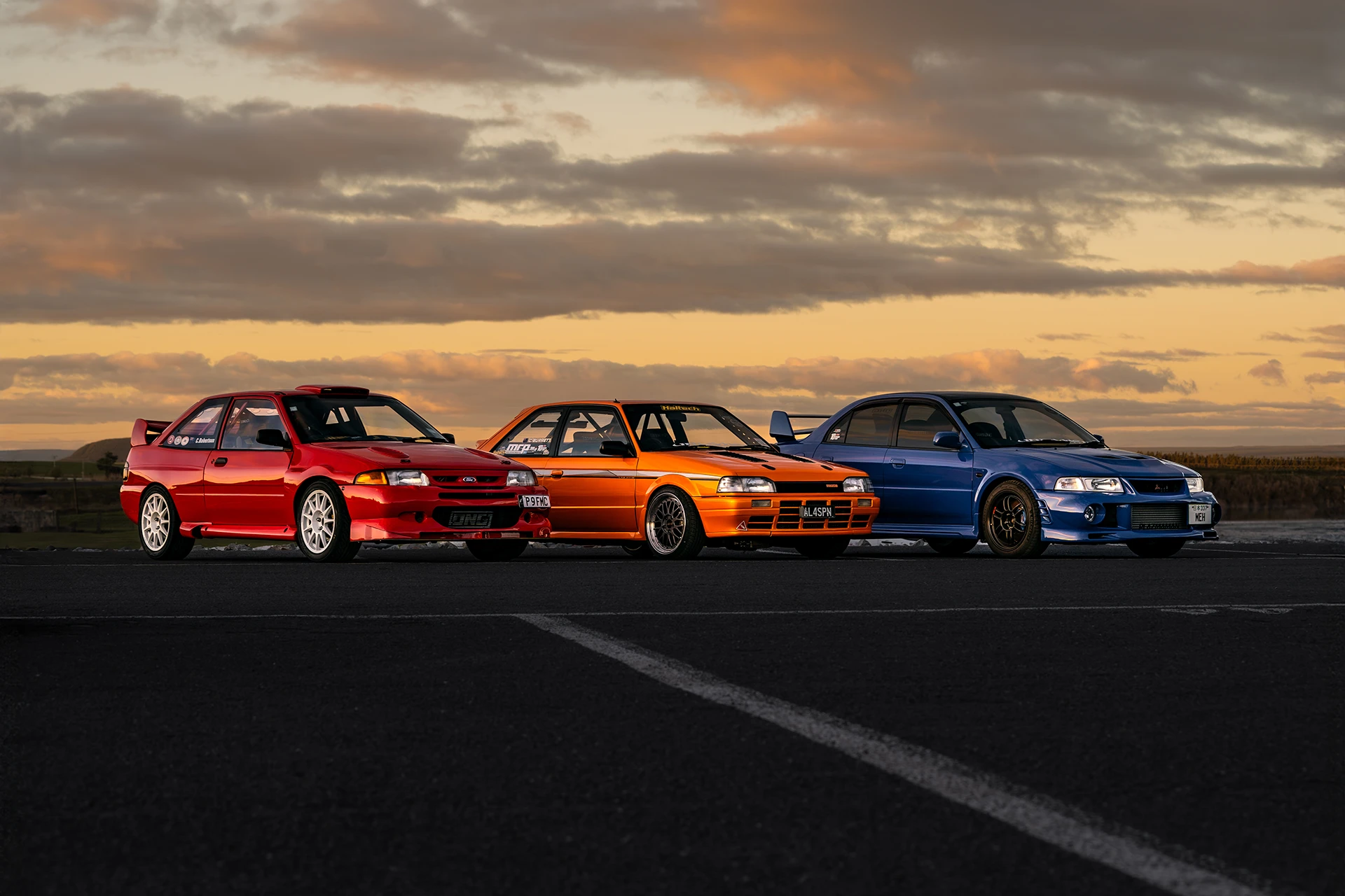Three sports cars in a New Zealand Sunset